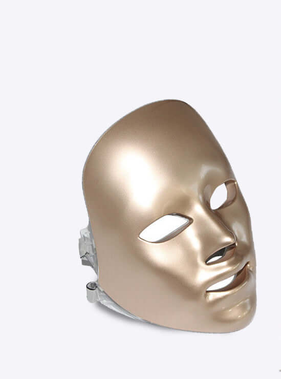 Woman using Led Facial beauty instrument with pink LED lights for skincare rejuvenation and treatment.