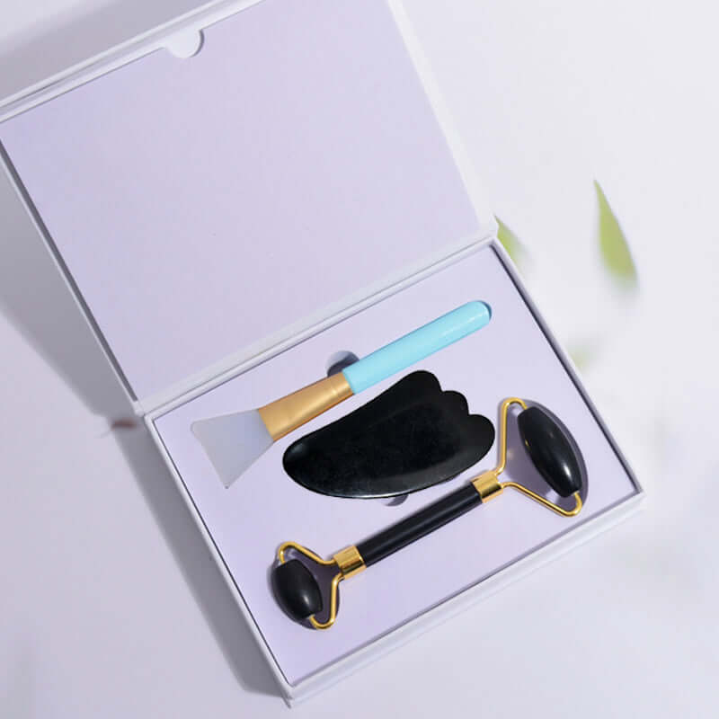 Beauty Face Care Massage Jade Device set including a jade roller and skincare tools in a box.